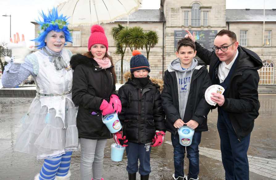 Madelyn and Charlie Wallis and Sonni Cragle enjoy the fun of the fair with magician Caolan McBride and a woodland fairy