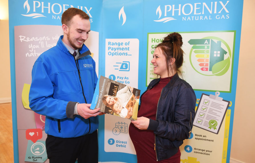 Leigh Dickson learning about the benefits of upgrading to natural gas at the Phoenix Energy information stand in Ards Art Centre with Energy Advisor Lachlan McNally
