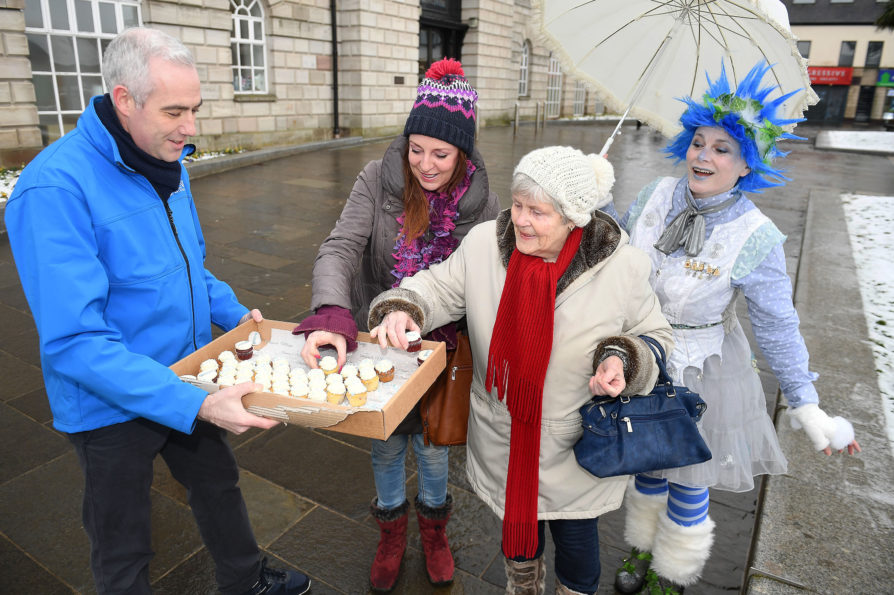 Local ladies Nuala McGuigan and Mary Kirk help themselves to sweet treats provided by Jonathan Martindale from Phoenix Energy