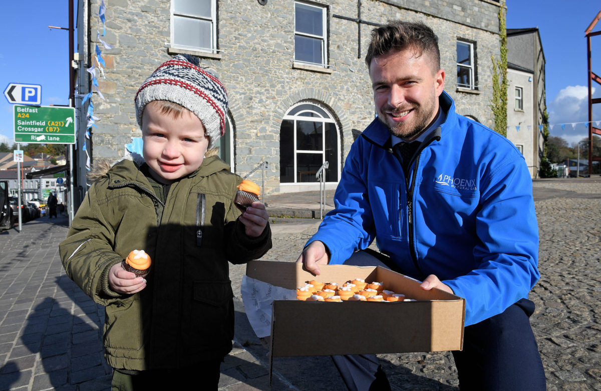 Three year old Shane McDonall enjoys some tasty spooky treats from Phoenix Energy Advisor, William Hutton 